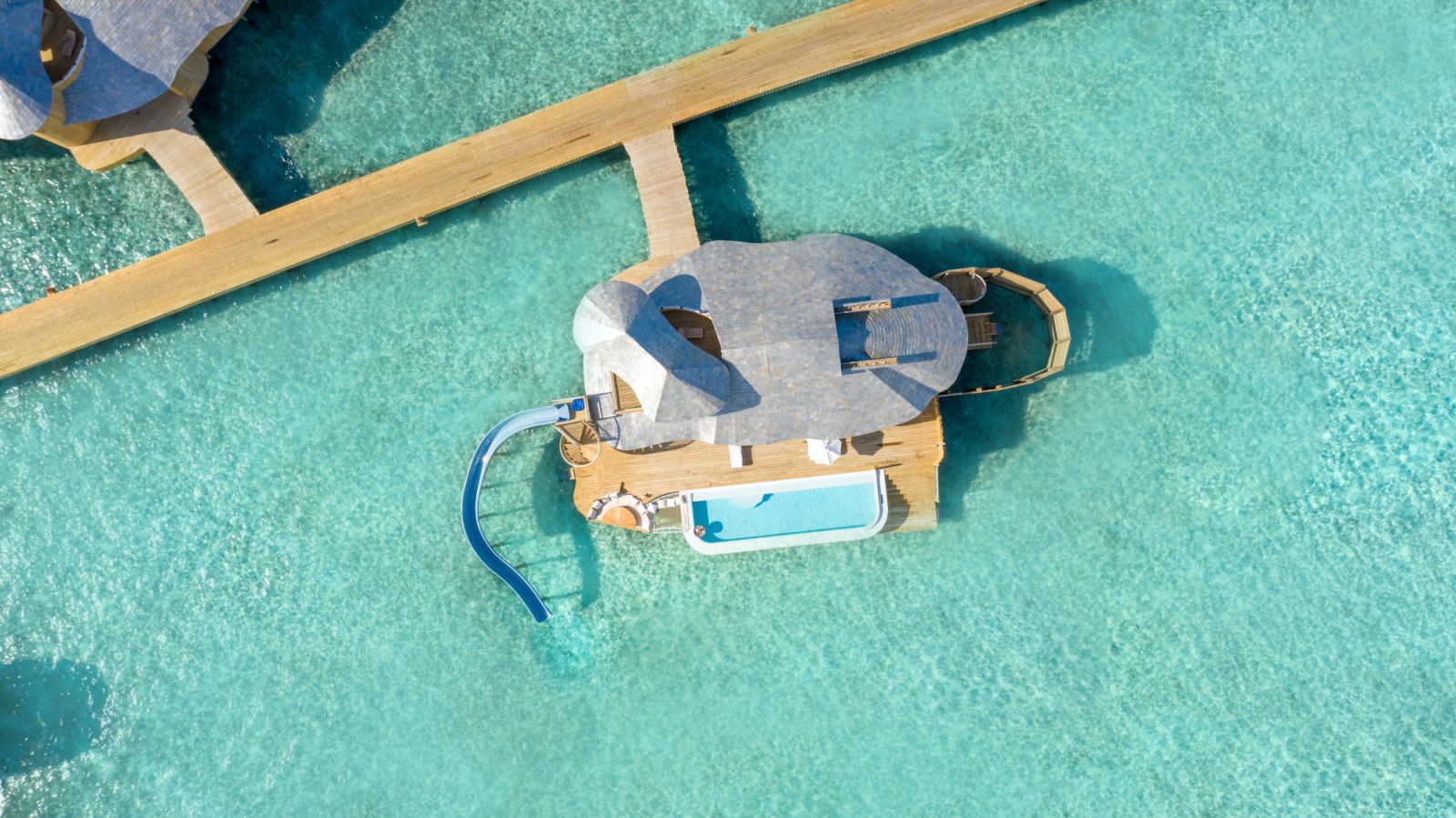 One-bedroom water reserve with slide exterior at Soneva Fushi