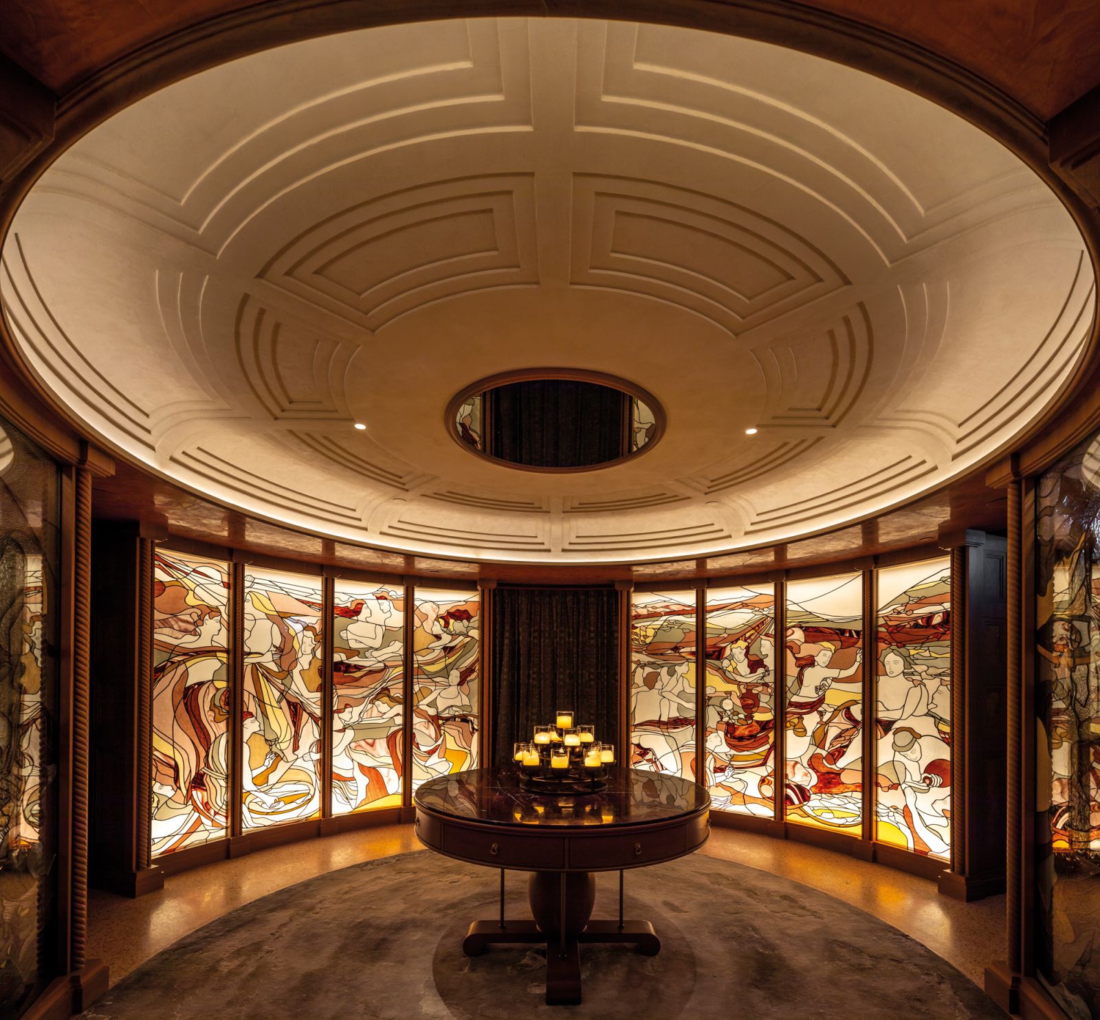 The grand arrival space at Carna features stained-glass art referencing ancient wall frescoes from Roman times