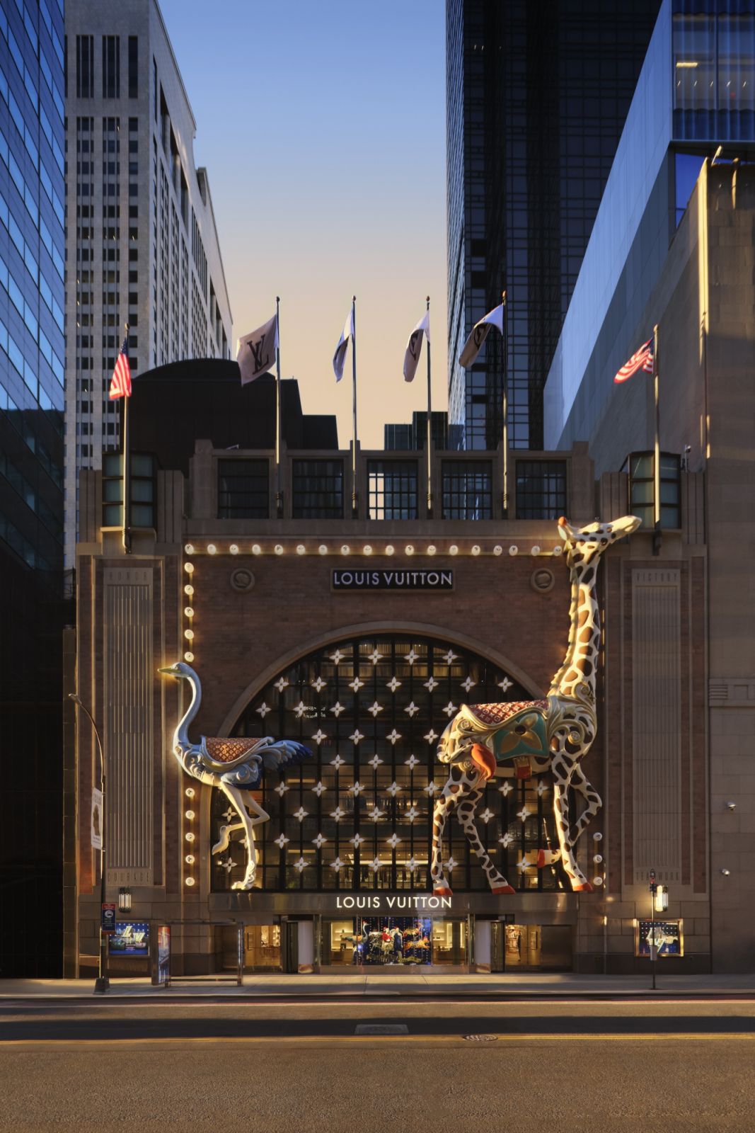 The facade of Louis Vuitton’s temporary space on 6 E. 57th St with  facade with illuminated Louis Vuitton signage and a whimsical holiday installation of carousel-inspired giraffes