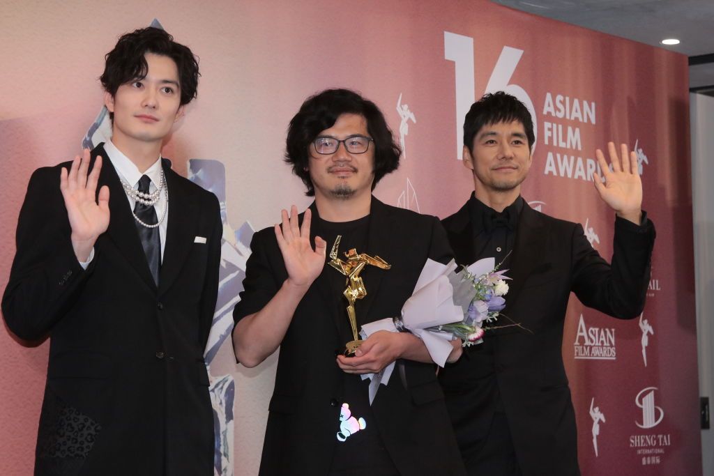 HONG KONG, CHINA - MARCH 12: Chinese cinematographer Lyu Songye (C) poses with his trophy and Japanese actors Hidetoshi Nishijima (R) and Masaki Okada during the 16th Asian Film Awards at Hong Kong Palace Museum on March 12, 2023 in Hong Kong, China. (Photo by VCG/VCG via Getty Images)