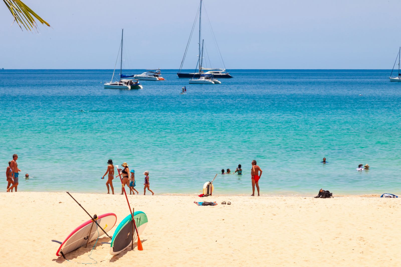 Thailand, nai harn beach - 03.30.23: beautiful bright nai harn beach in thailand on phuket island with clear turquoise water in the sea, white sand and blue sky. A popular tourist place
