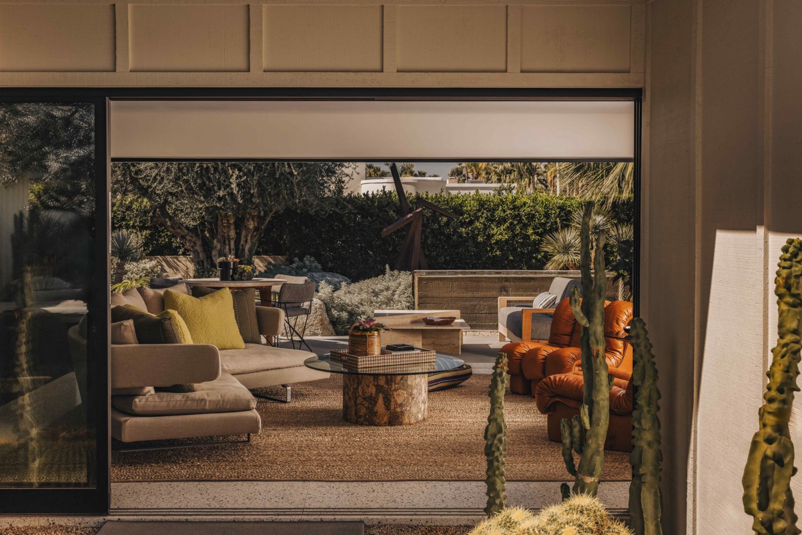 Large, retractable sliding glass doors open to a manicured backyard