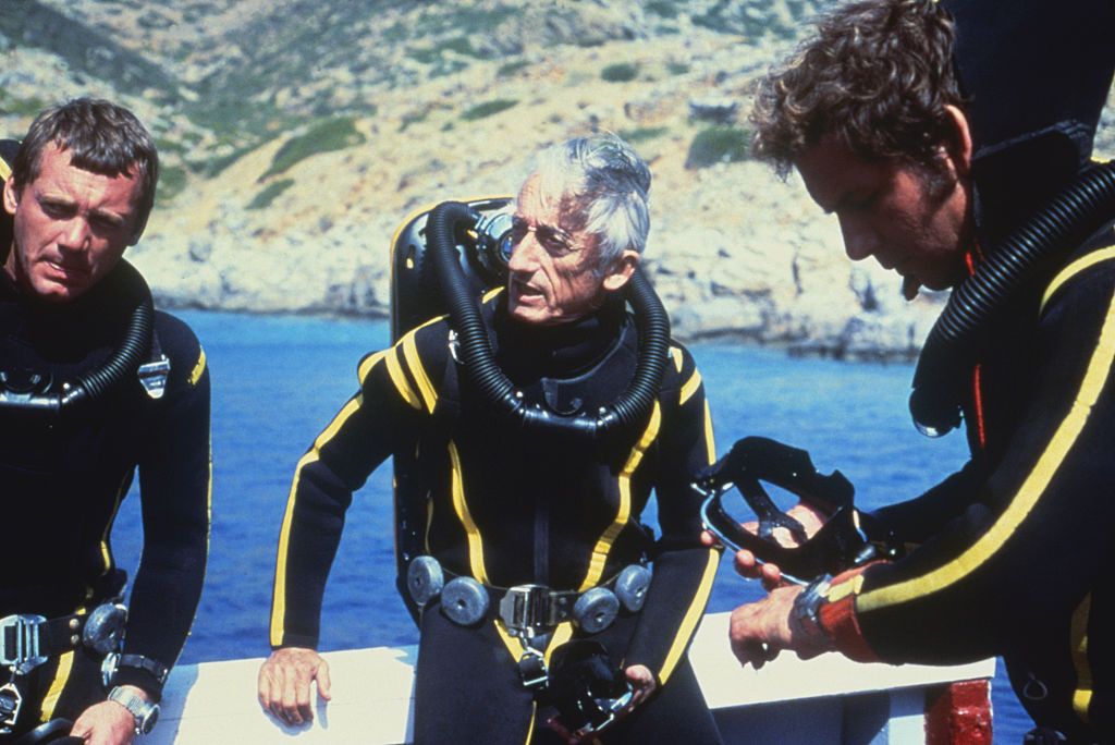 Oceanographer Jacques-Yves Cousteau (centre) and colleagues preparing for a dive wearing wet suits and scuba gear (Photo: Getty Images)