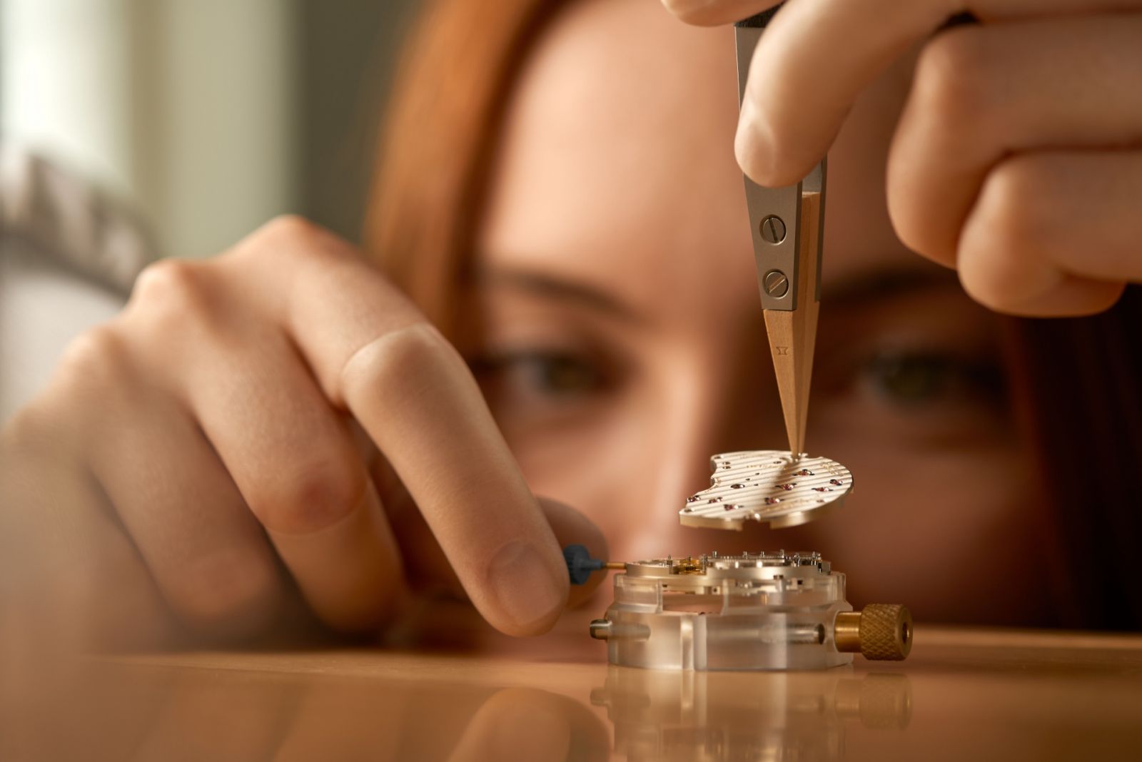 A. Lange & Söhne watch assembly: The watchmaker assembles the three-quarter plate. The soft structure of the untreated German silver requires extra attention to avoid scratches.