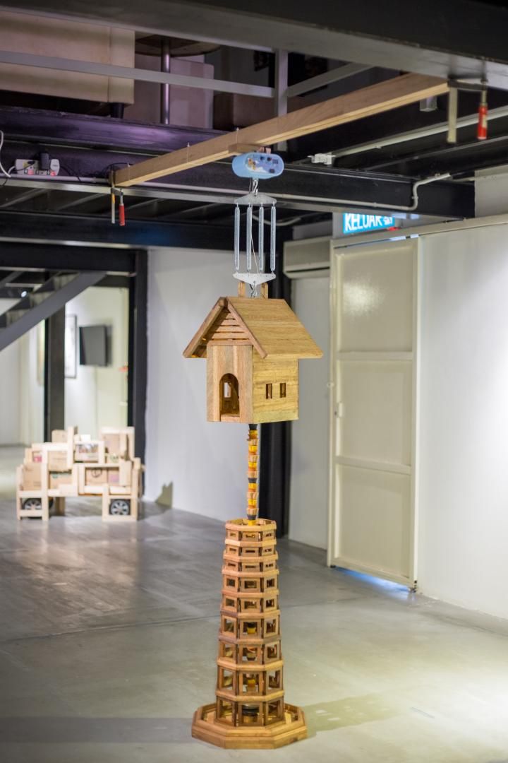步步高升 - “May you rise to greater heights with each step”; wood, incense, Chinese cymbal, steel, paper mache with gold leaf, LED light bulb, automatic baby cradle