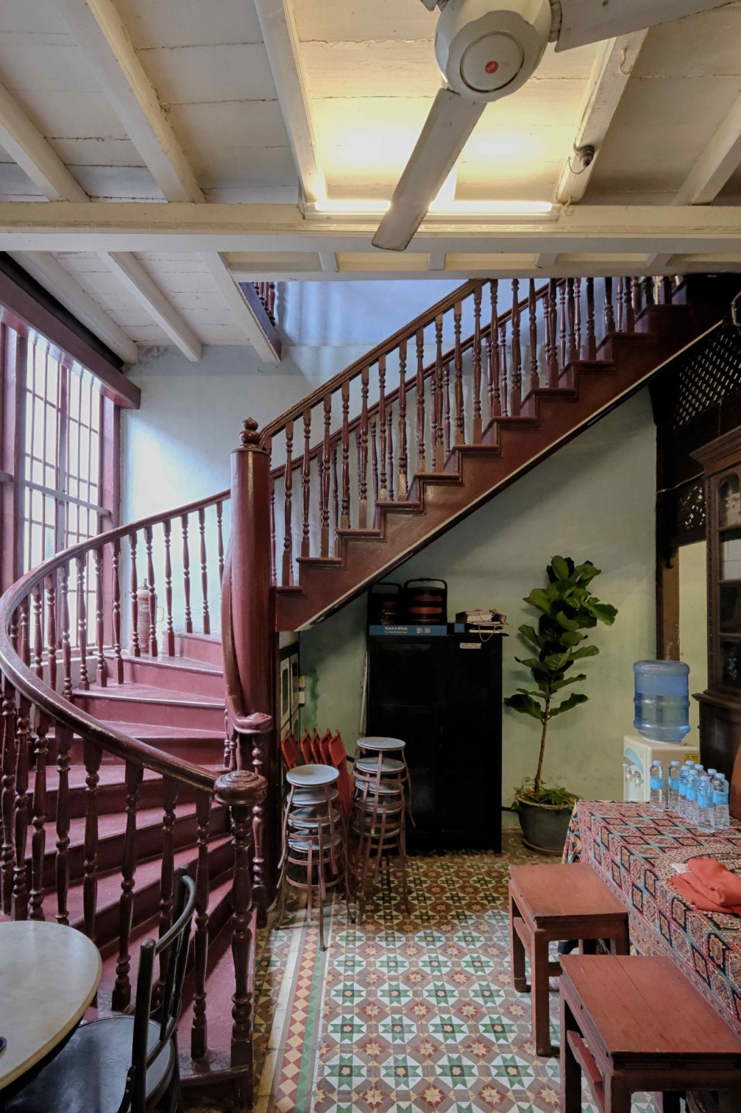 The winding staircase demonstrates space-saving ingenuity in the narrow layout of shophouses