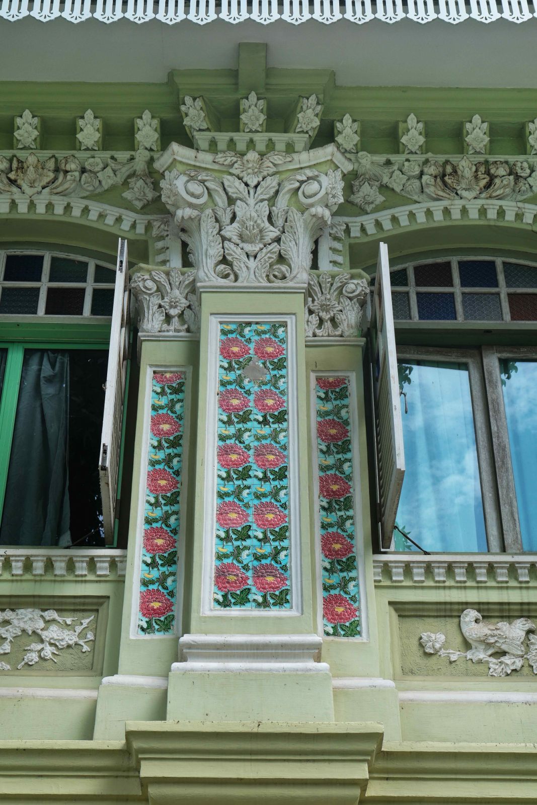 Colourful floral patterned ceramic tiles and plaster ornamentation of animal and floral motifs