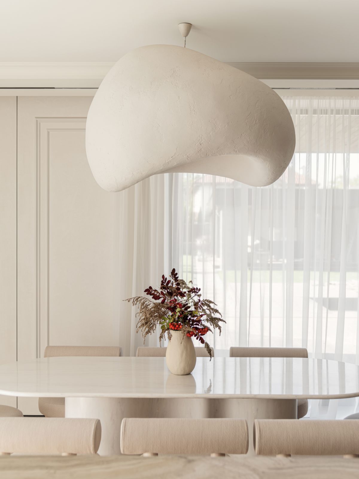 An oversized sculptural pendant light creates visual interest