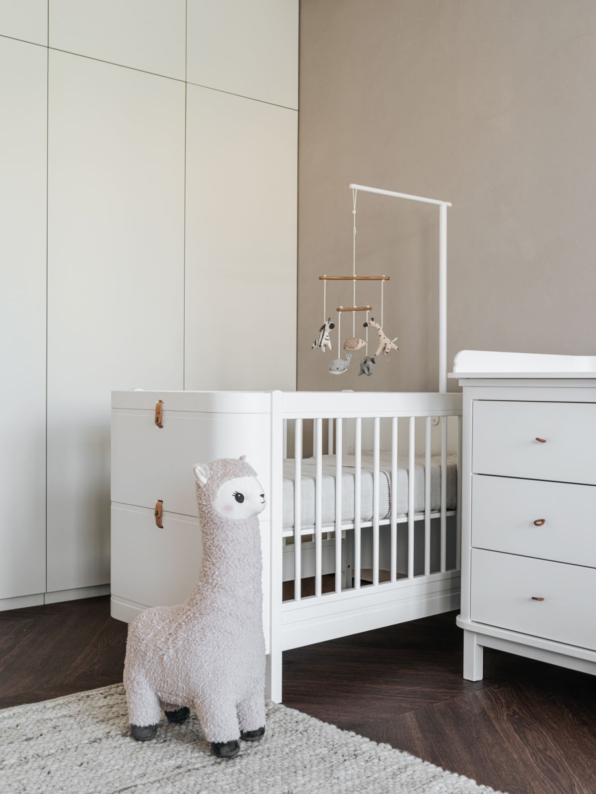 The pastel-toned nursery follows the aesthetics of the rest of the home