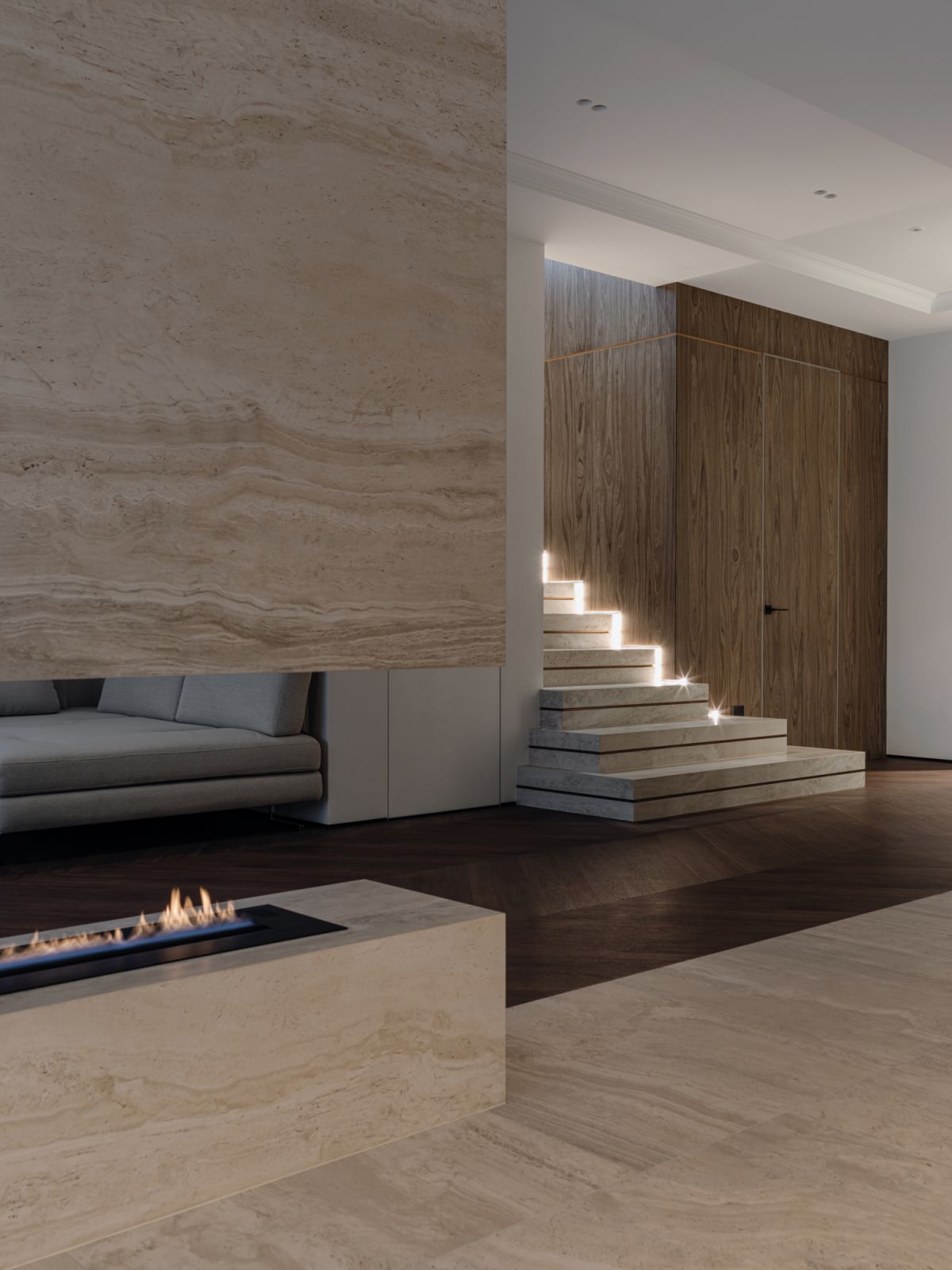 The gap carved in the feature wall for a fireplace also creates a visual connection between the living and dining zones