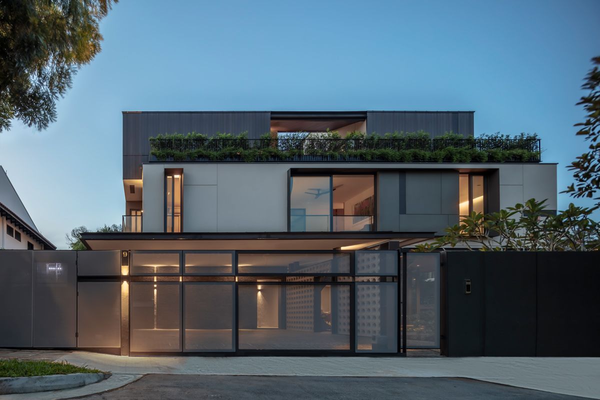 An evening view of the Bukit Timah house reveals the transparency of the fence