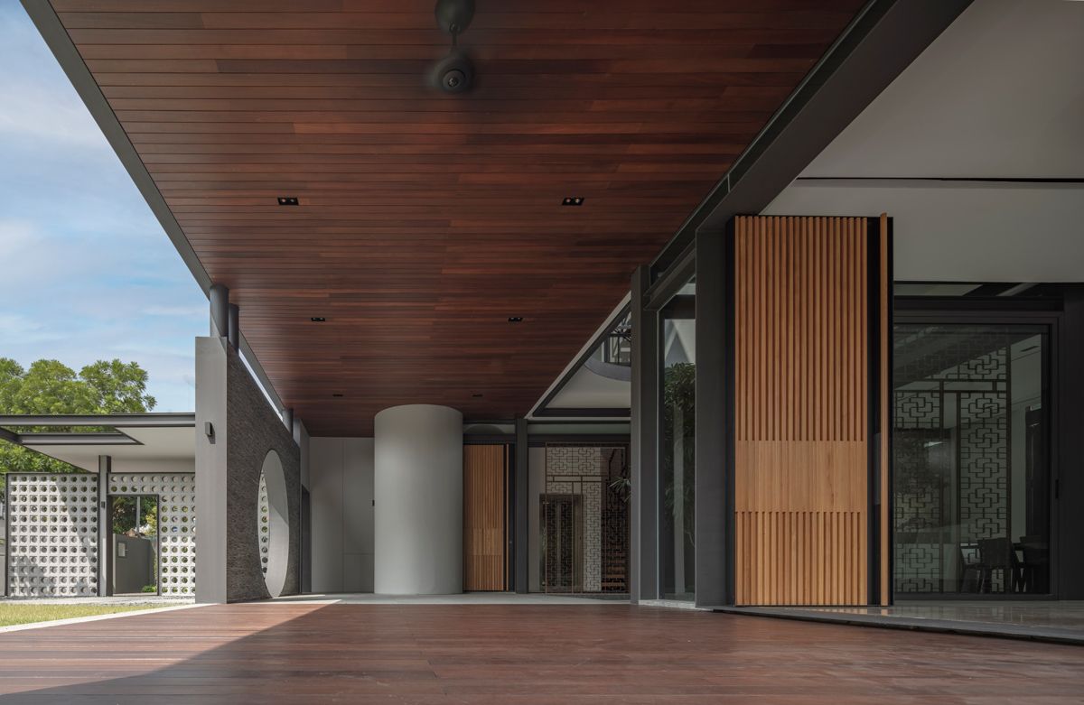 The porous architecture allows breeze and drizzle to enter the home, the owners consider a perk of living in tropical environment
