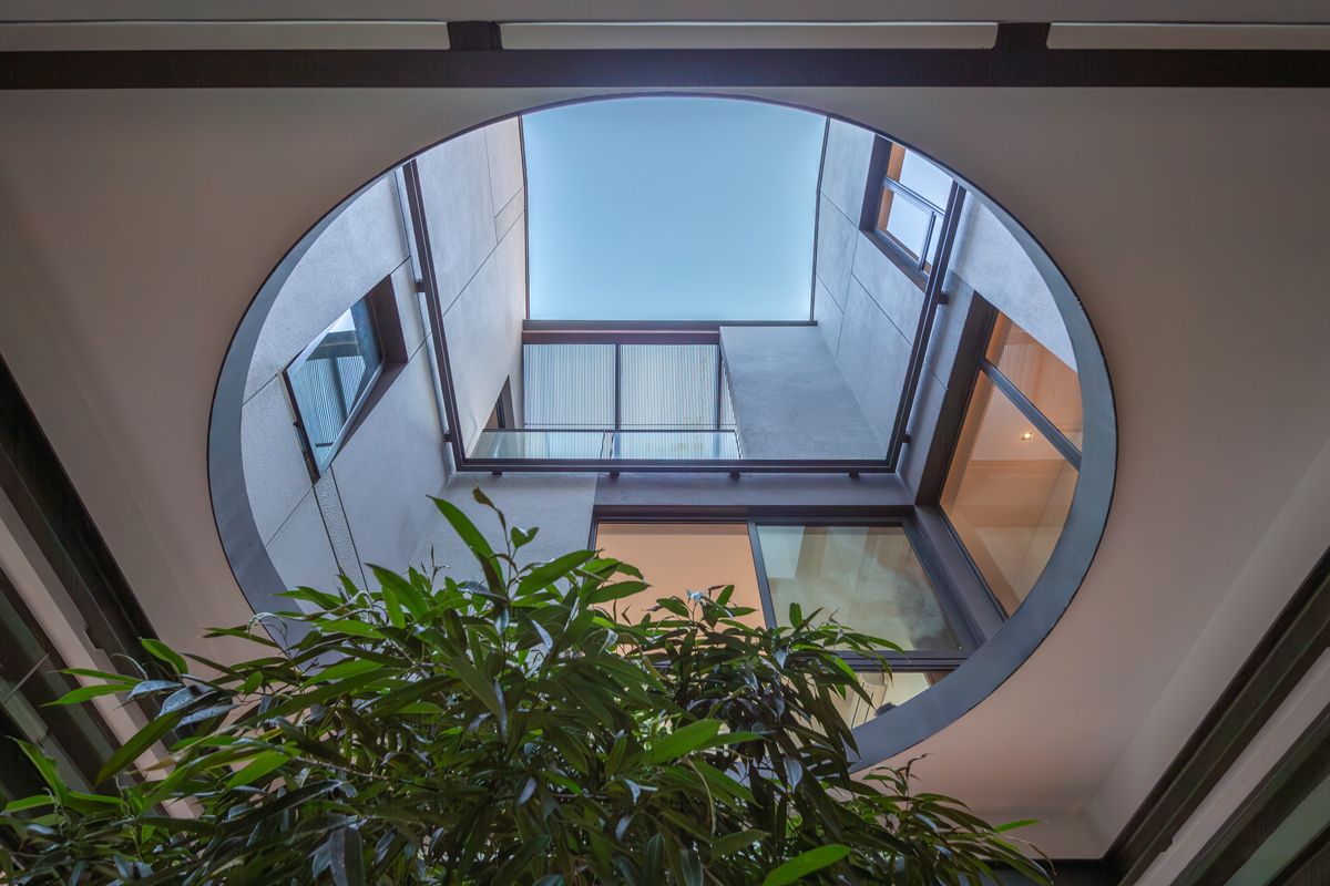 The circular opening in the courtyard is a nod to the traditional Chinese moon gate