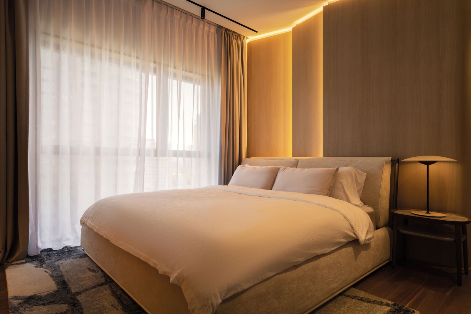 The bedroom, with its dim lighting, evokes an intimate ambience perfect for relaxation