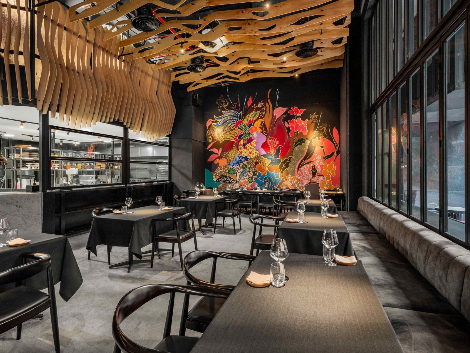 The vibrant floor-to-ceiling mural in the monochromatic dining area (Photos: Beta KL)