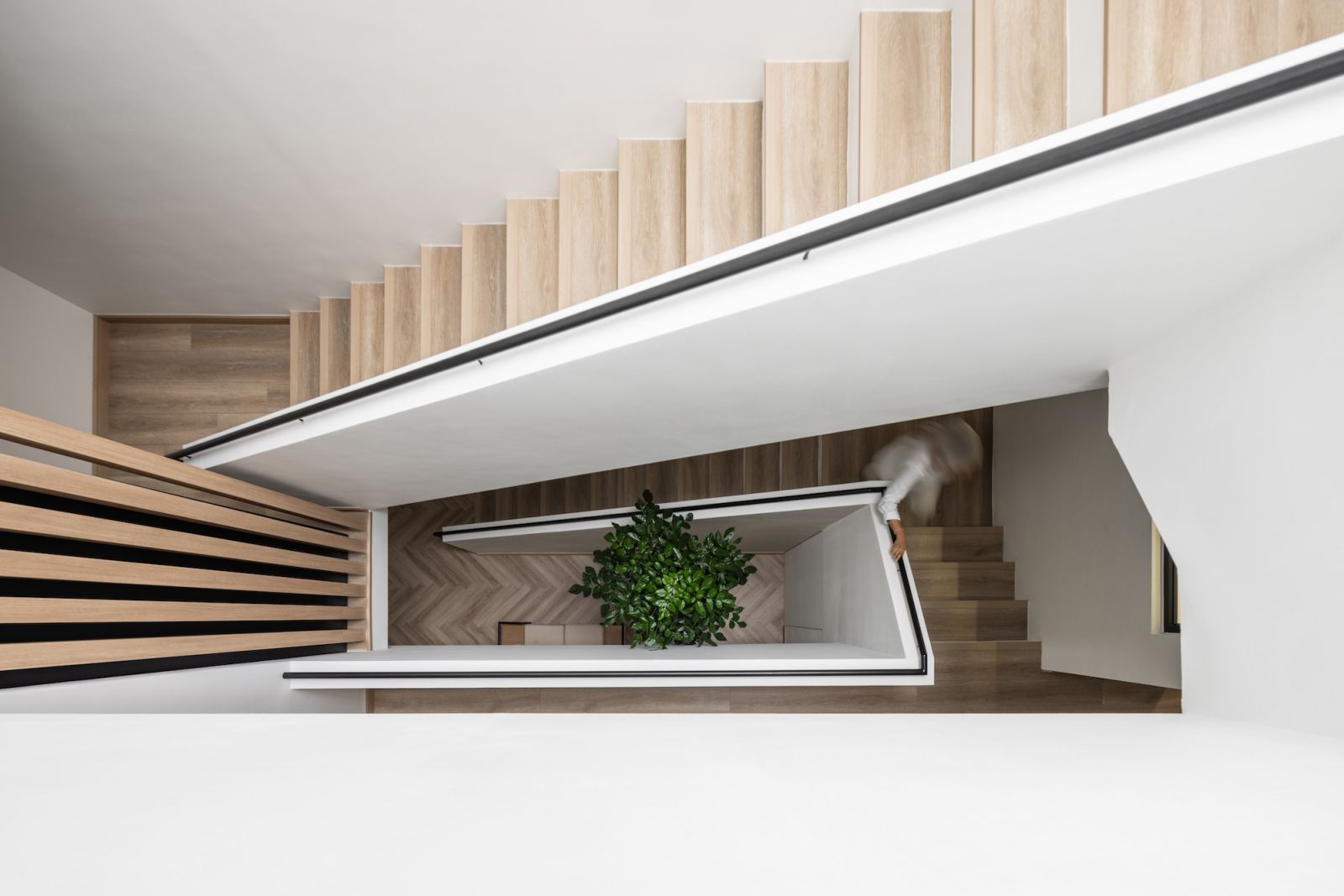 The staircase is bathed in natural light courtesy of the skylight