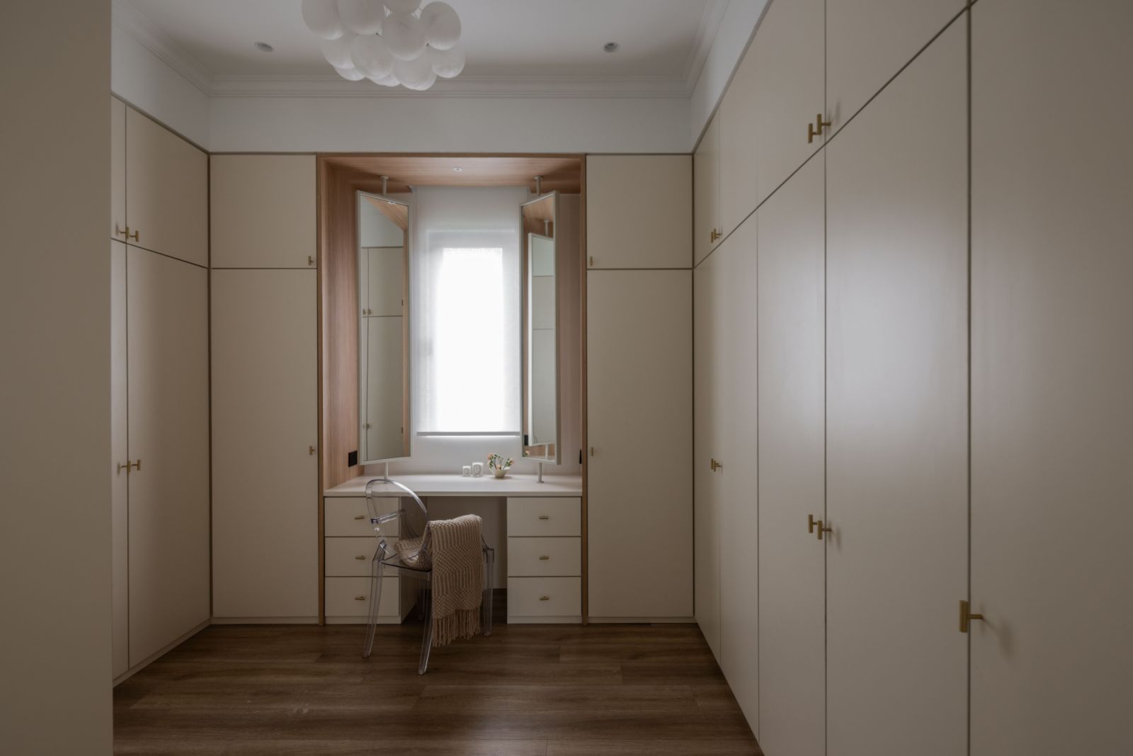 Custom joinery in warm timber tones maximises storage while maintaining the home's clean aesthetic