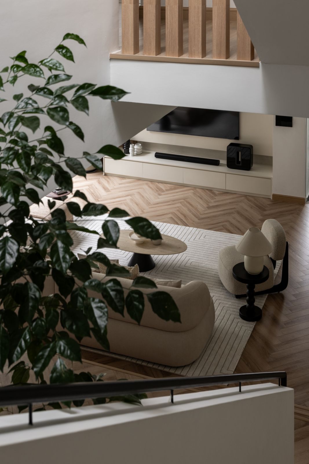 The living space showcases Framework Studio’s minimalist aesthetic, featuring custom-built storage solutions and herringbone timber flooring