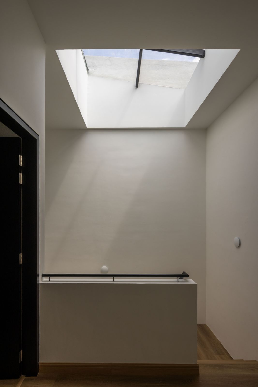 A strategic architectural intervention, the skylight functions as a natural light well, drawing daylight deep into the home's core