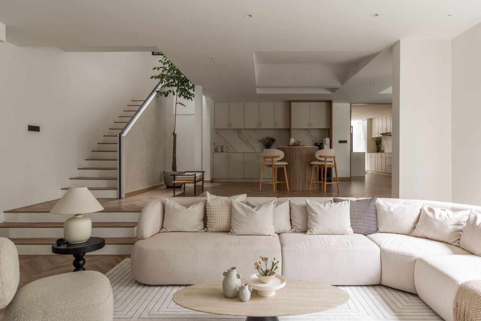 Softly curved seating and tables create a gentle counterpoint to the home's geometric architecture