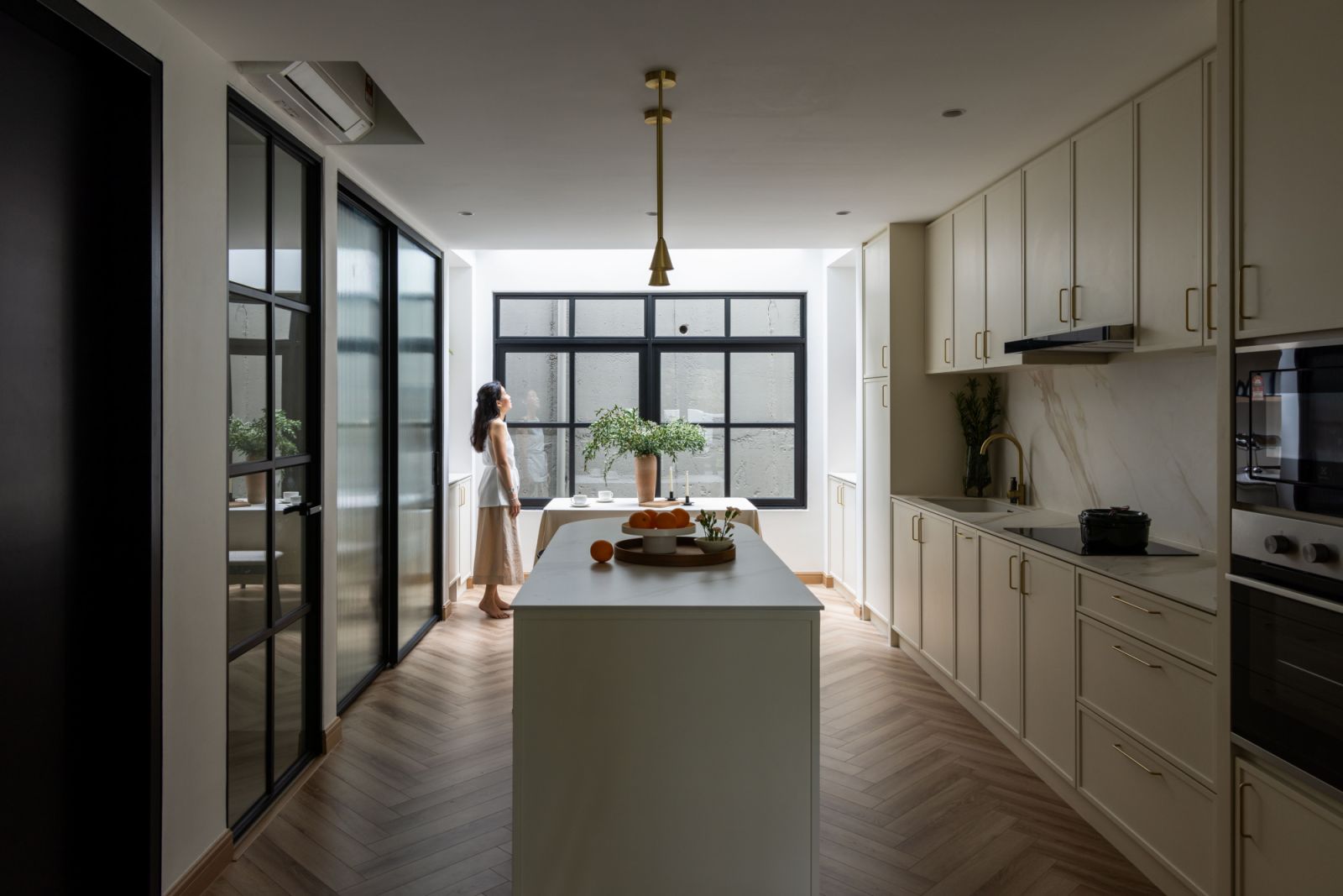 The kitchen features a practical layout enhanced by a skylight, bringing natural illumination to the cooking and gathering space.