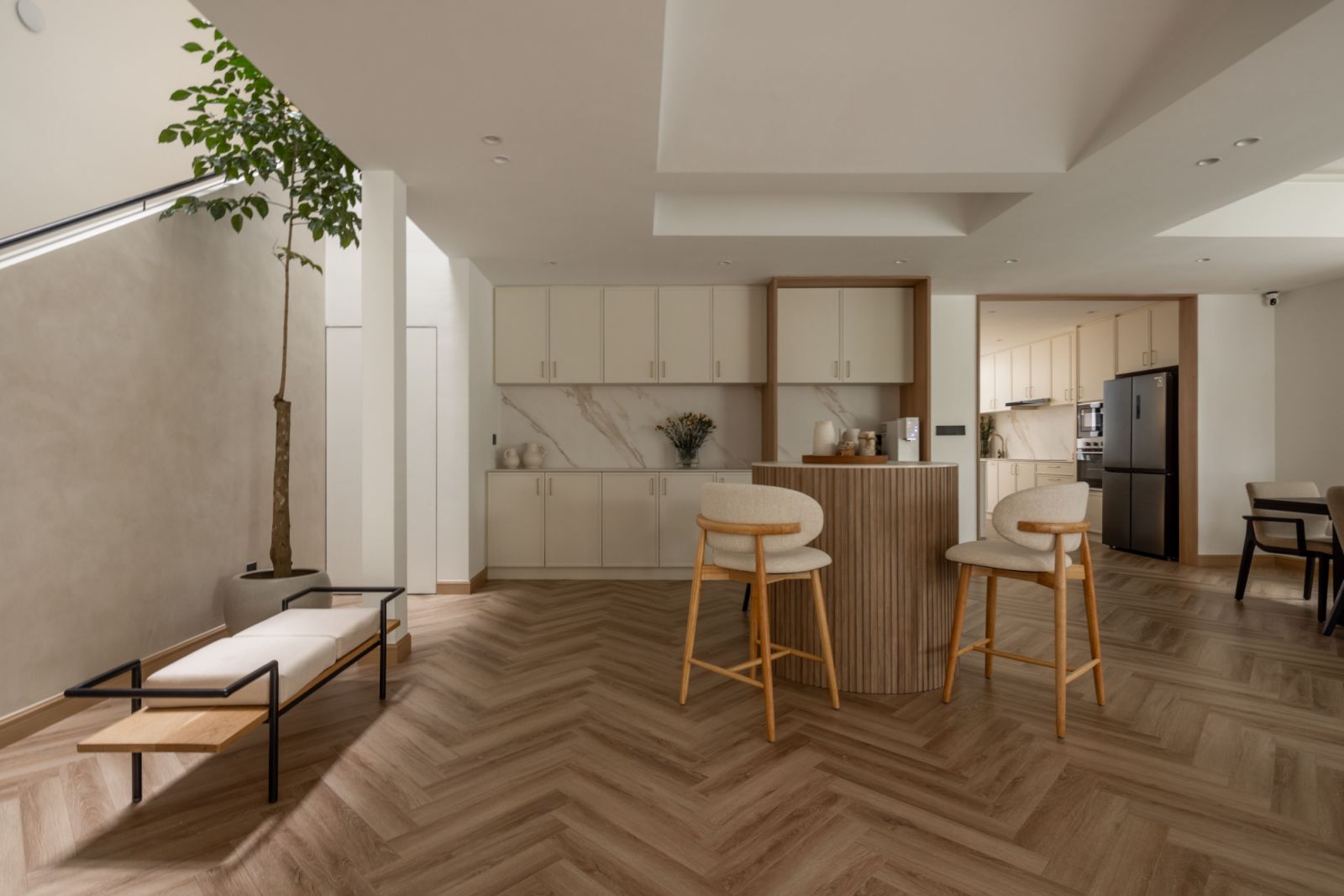 The rounded forms, rendered in warm neutral tones, add a sense of comfort and fluidity to the minimalist space, while echoing the natural shapes of the indoor plants that bring life to the interior