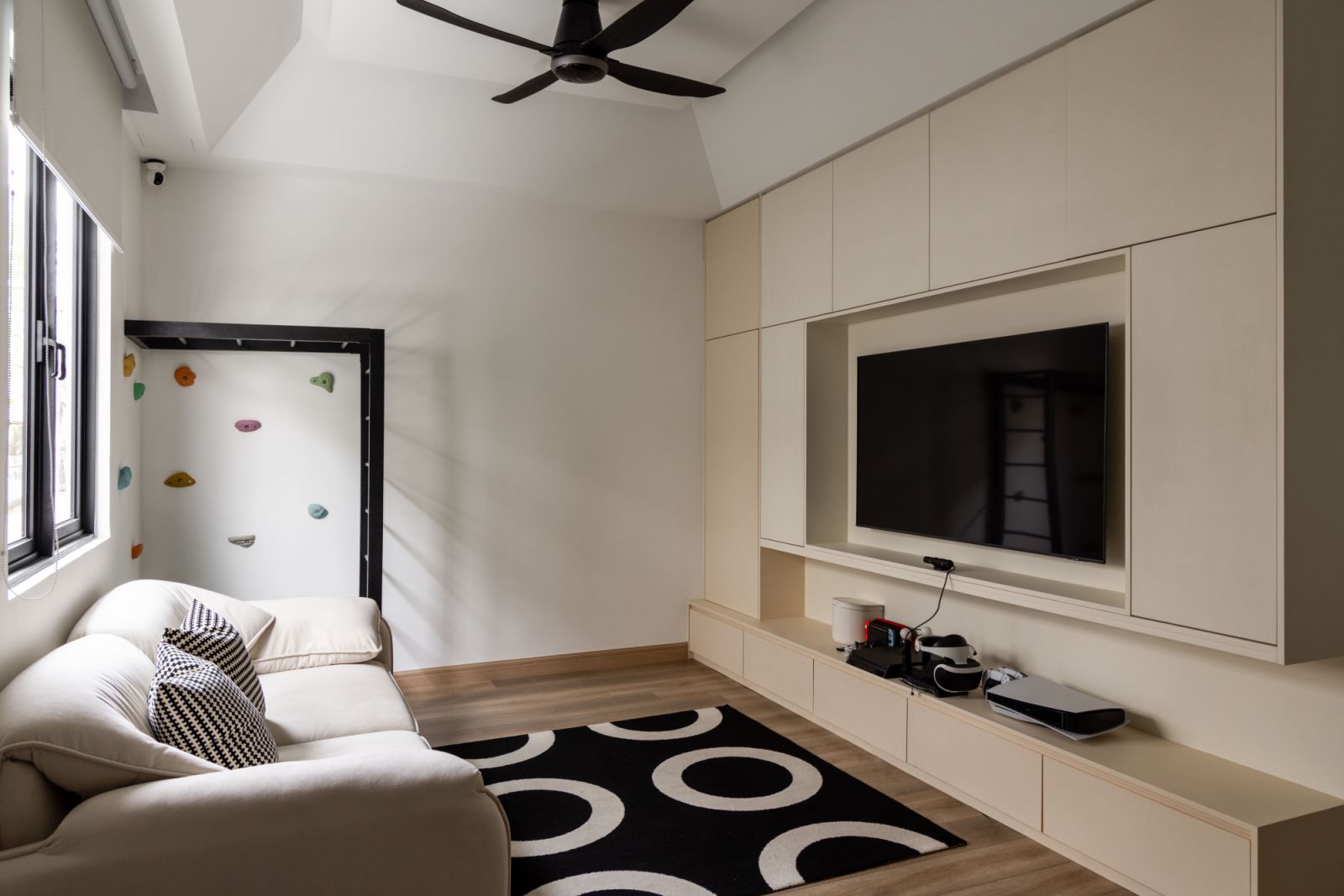 The family room is a flexible space that adapts to the family's changing needs throughout the day, from morning homework sessions to evening relaxation