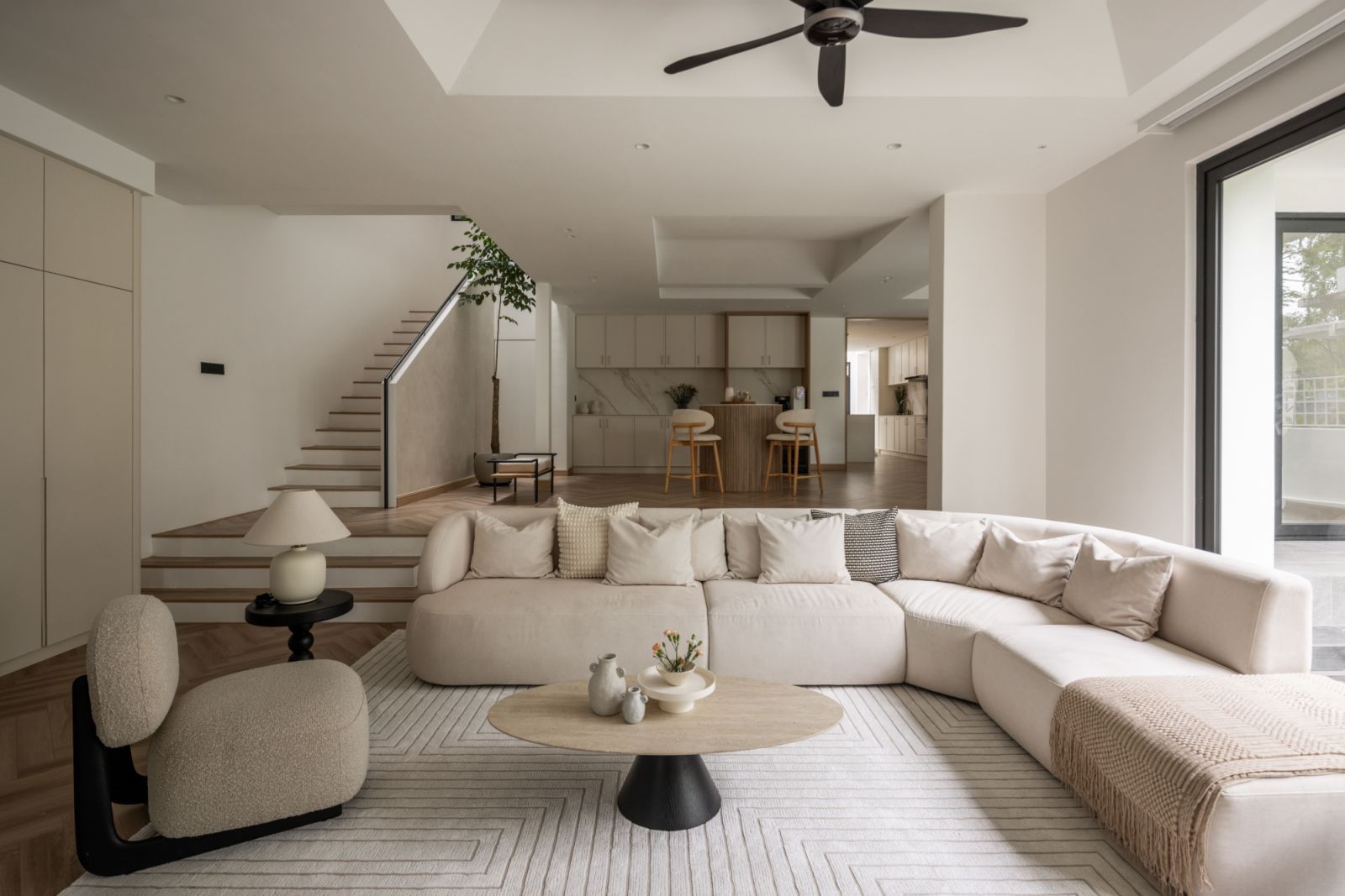 Softly curved seating and tables create a gentle counterpoint to the home's geometric architecture