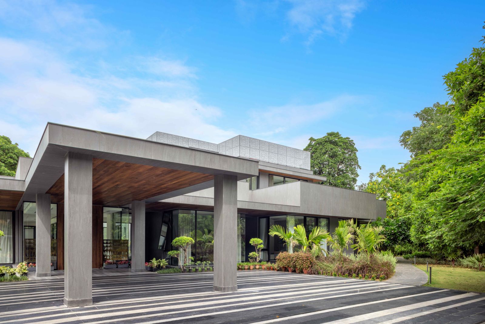 The exposed concrete façade at the driveway entrance