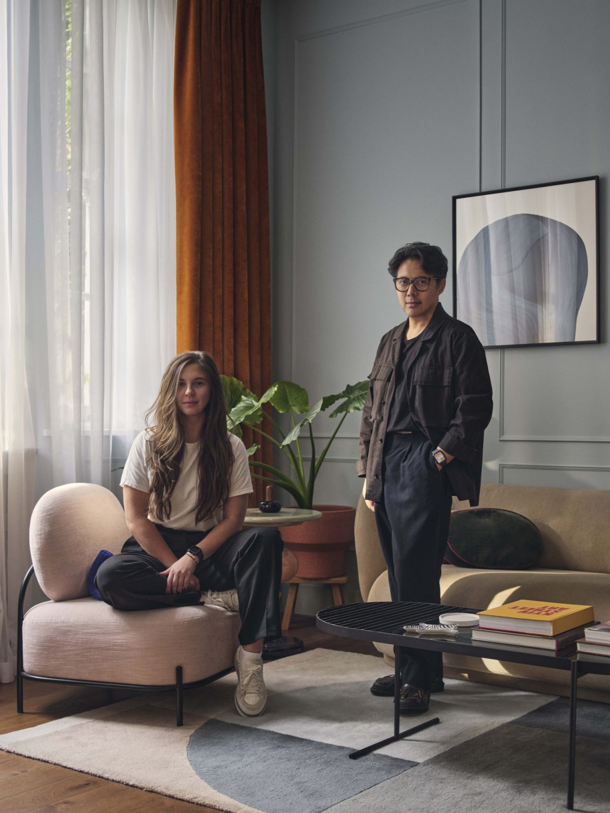 Maison RA-D founder and design director Rodney Alday with team designer M Logvinova. Behind them is art by Ronan Bouroullec, curtains and sheers by Dedar and Pierre Frey, a rug by Urd Moll Gundermann for Linie Design, plus a bespoke armchair and coffee table (Photo: Nick Rochowski)