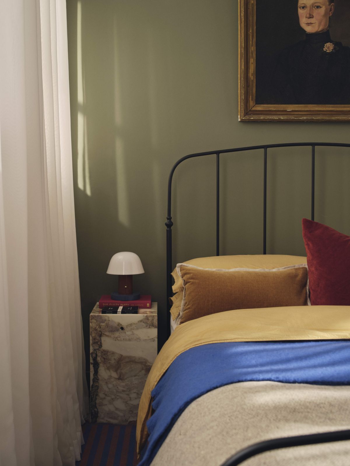 The bedroom features a marble table from Audo Copenhagen, fabrics and beddings from Design Centre Chelsea Harbour, a bed frame from 1st Dibs and an oil painting by G Le Paye, 1888 (Photo: Nick Rochowski)