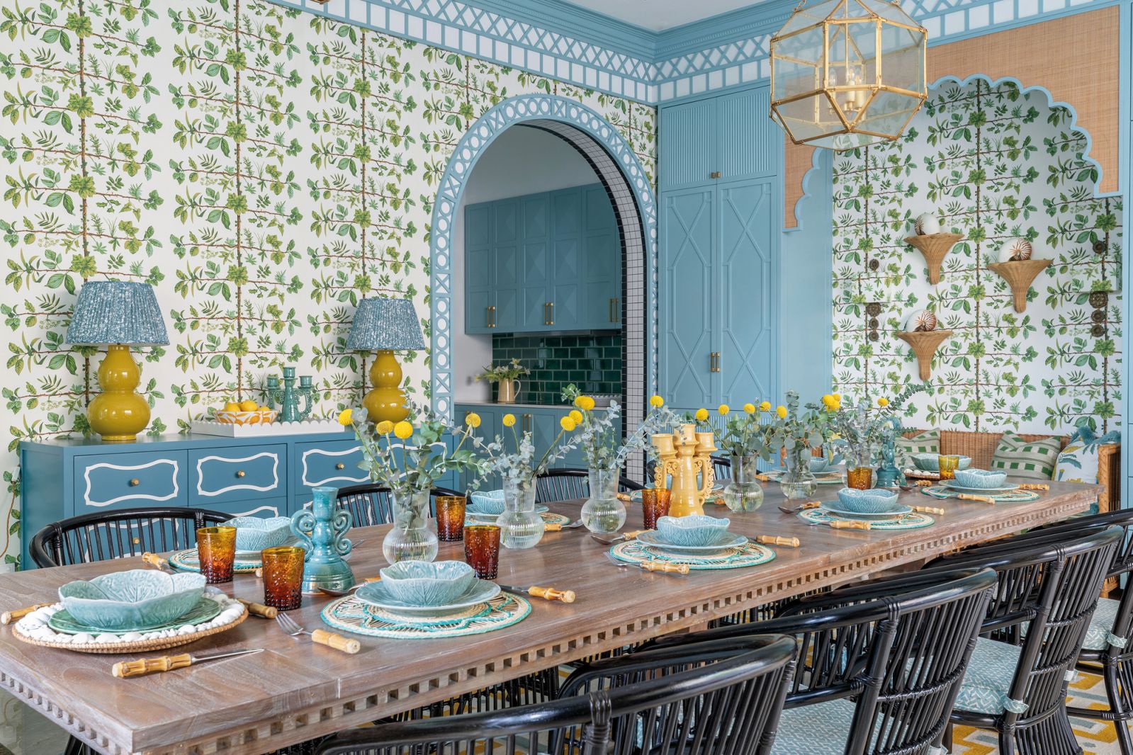 The dining room is clad in a Pierre Frey wallpaper that mimics the unique look of espaliered trees, which are grown flat against a wall