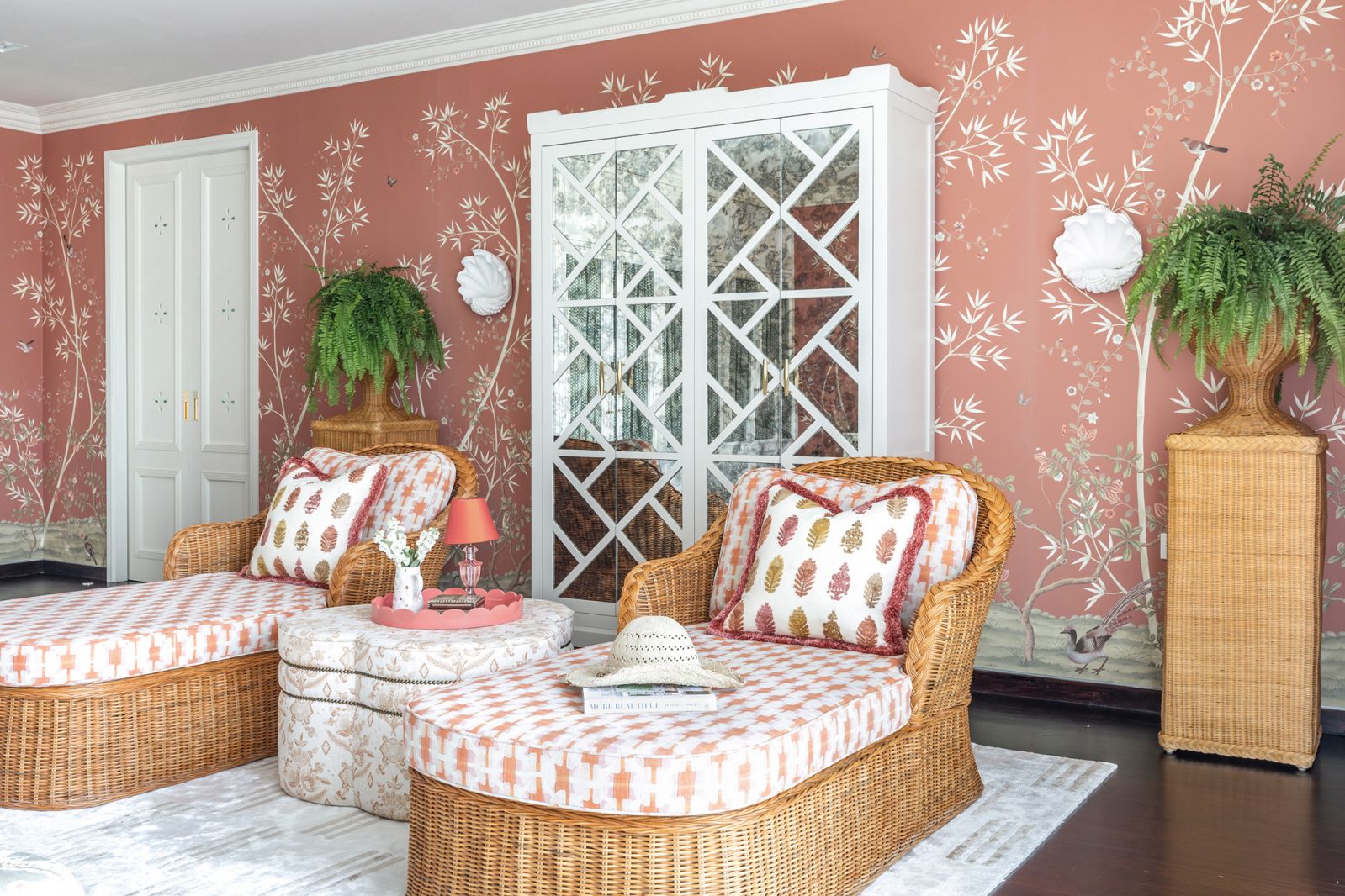 The master bedroom is a serene sanctuary with walls clad in a fetching chinoiserie-themed wallcovering from Fromental
