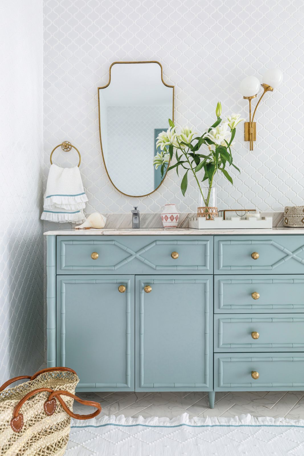 The bamboo vanity in the master bathroom was resprayed in a dainty seafoam shade