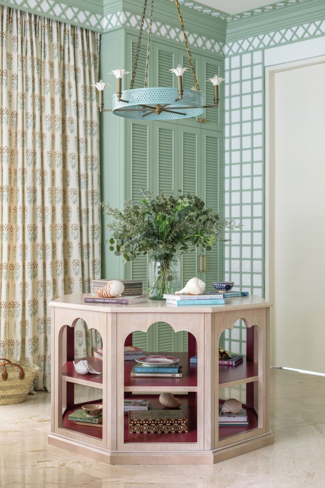 The living area features an assortment of furnishings and decorative items such as handcrafted furniture from Asia