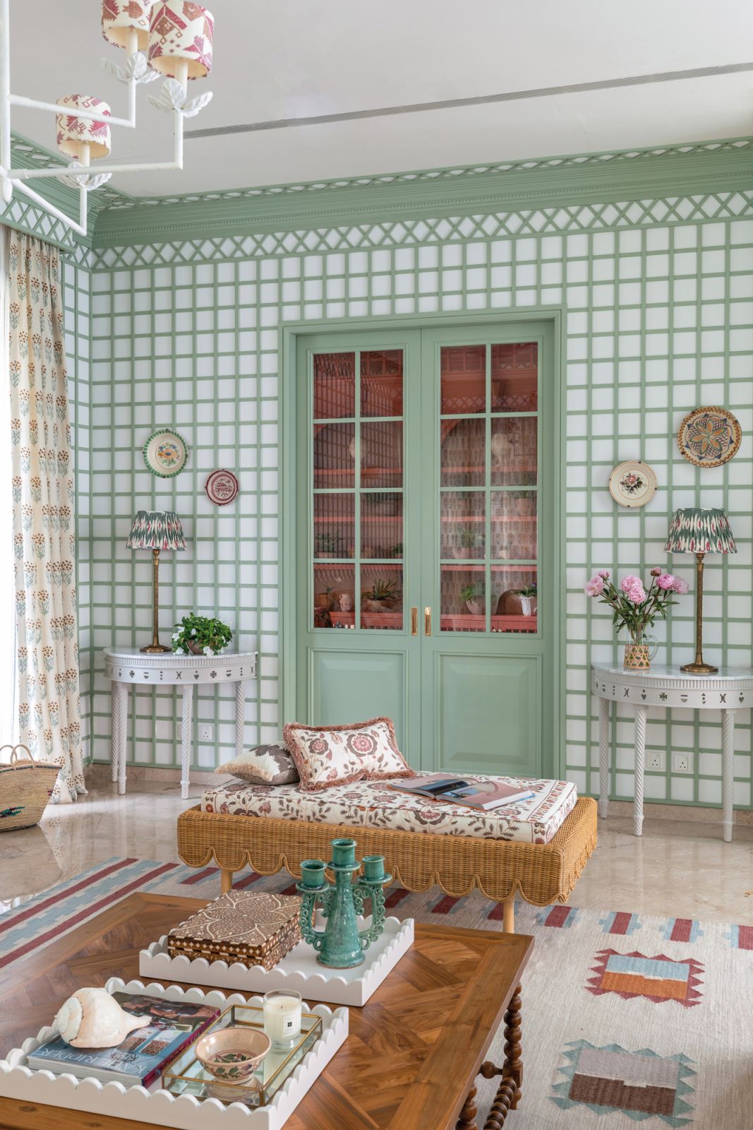 The home’s continental wallpaper and upholstery, antique plates from Spain and Vaughan brass lamps