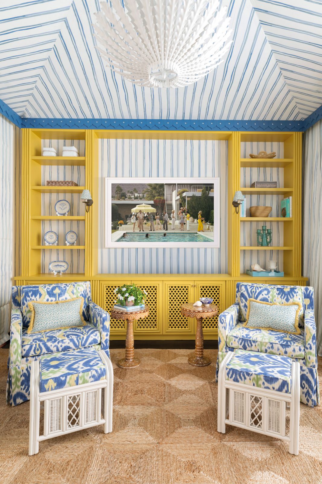A print by American photographer Slim Aarons is bordered by a bamboo cabinet painted in an energetic yellow hue