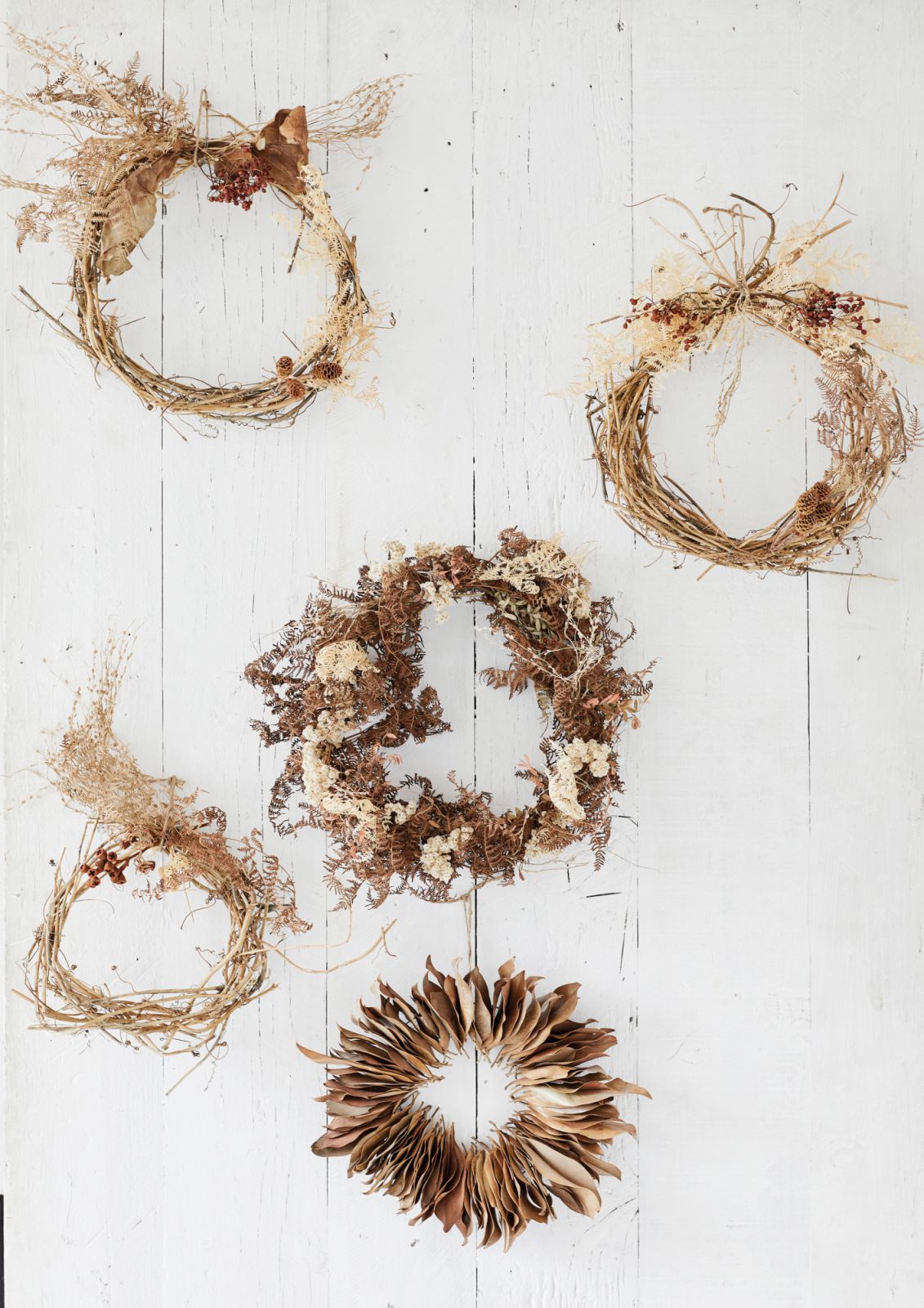 Sophisticated Christmas wreaths made of dried and preserved leaves, stems and flowers