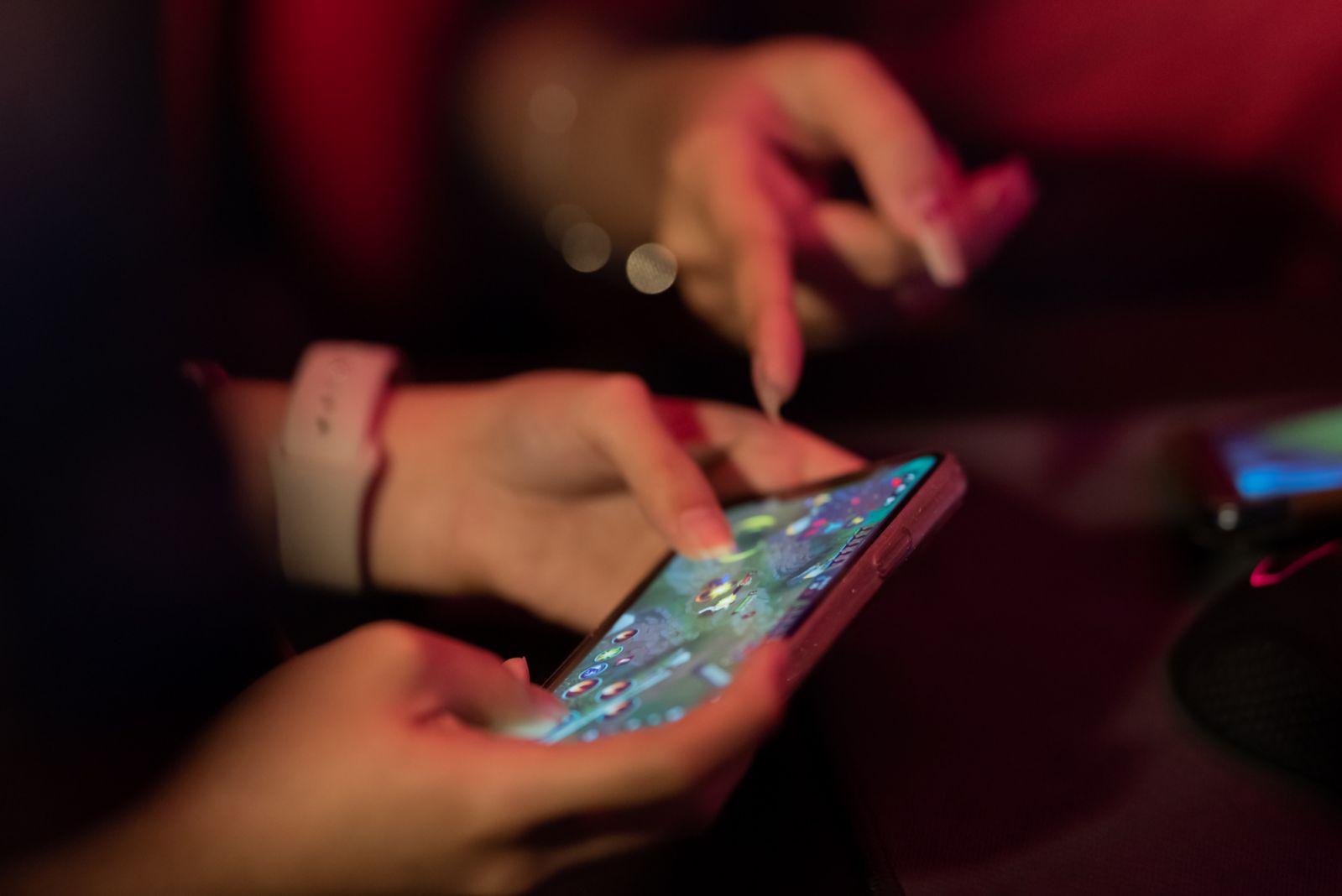 Asian female gamer in smart phone game practicing close up hand