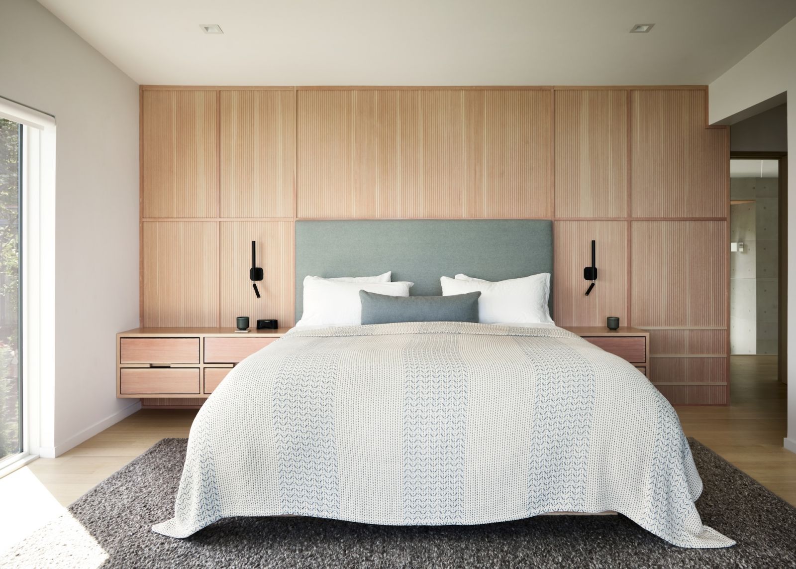 The primary bedroom in soothing shades of cream, teal and grey