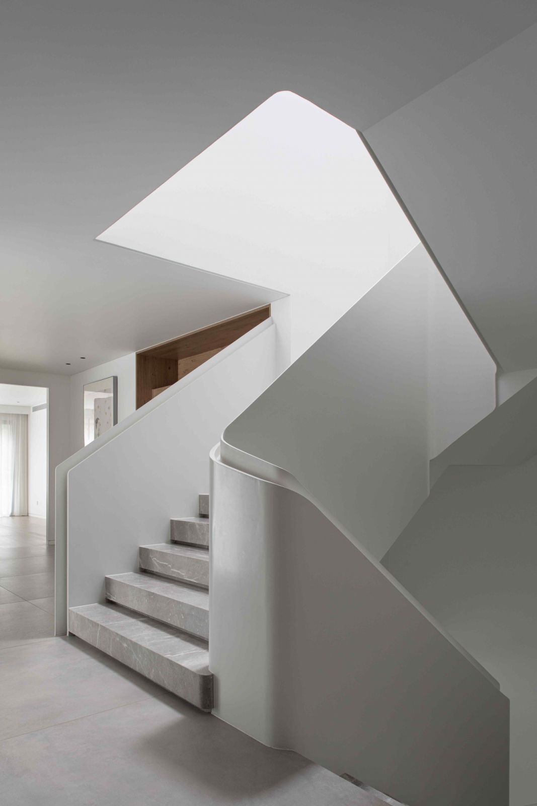 The skylight highlights the transparent balustrades of the staircase