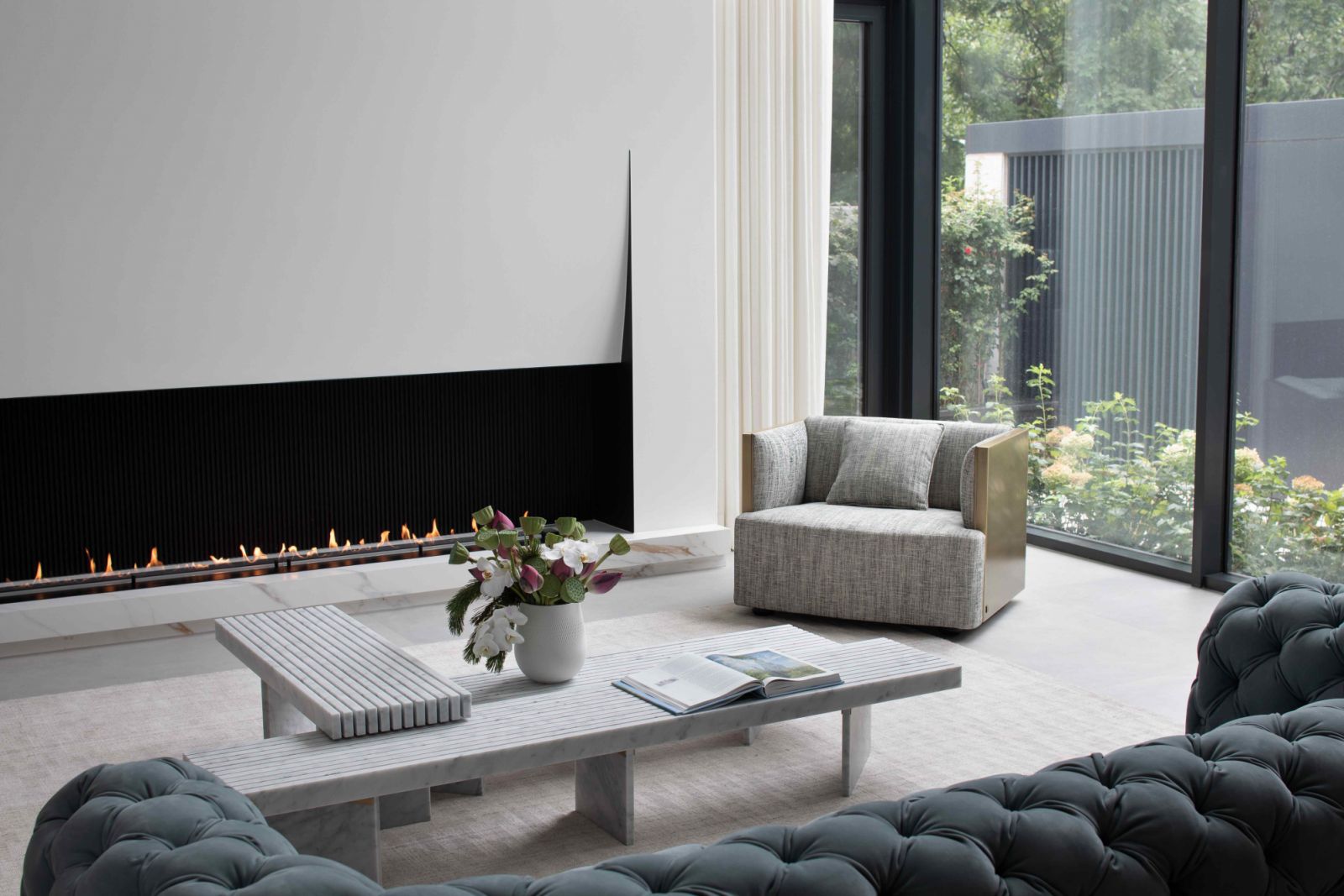 The subtle and abstract form of the fireplace appears as a minimalist opening in the wall