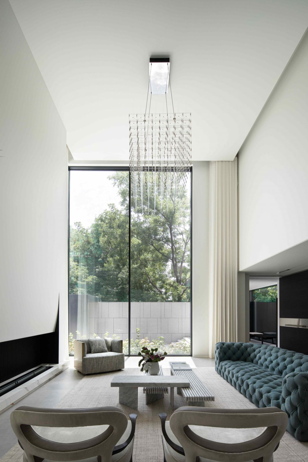 A delicate chandelier reminiscent of a floating three-dimensional grid, hovering from the six-metre tall ceiling