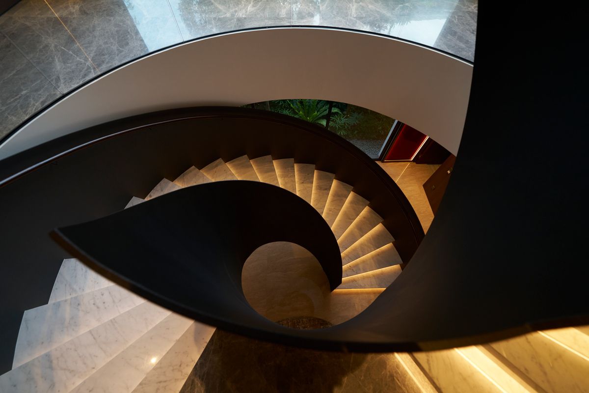 This bird’s-eye perspective reveals a captivating interplay between its robust steel structure and backlit marble steps