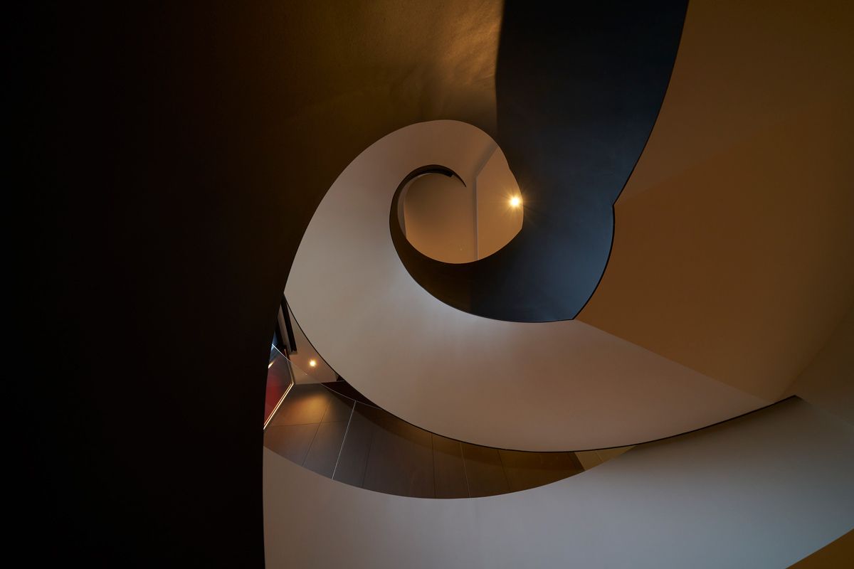 The black and white contrast of the staircase highlights its clever geometry