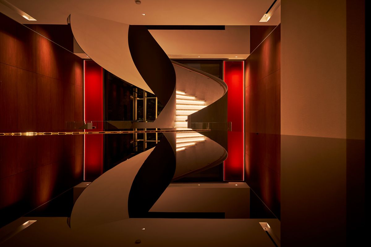 A stunning view of sculptural staircase seen from a high-gloss surface
