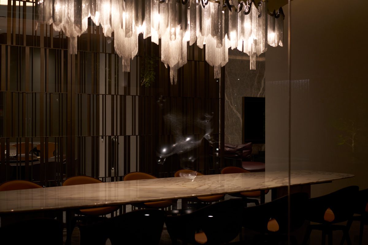 The dining room's modern chandelier reminds one of winter icicles
