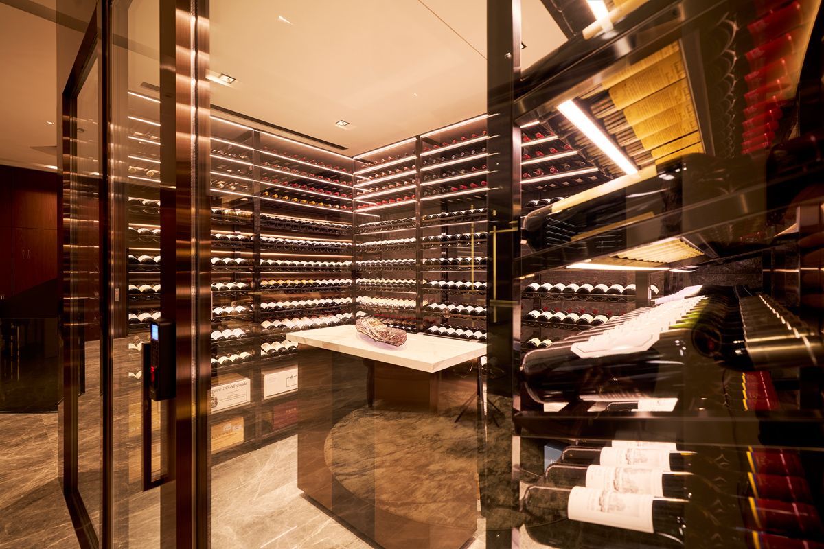 The climate-controlled wine room is meticulously lit to display its content