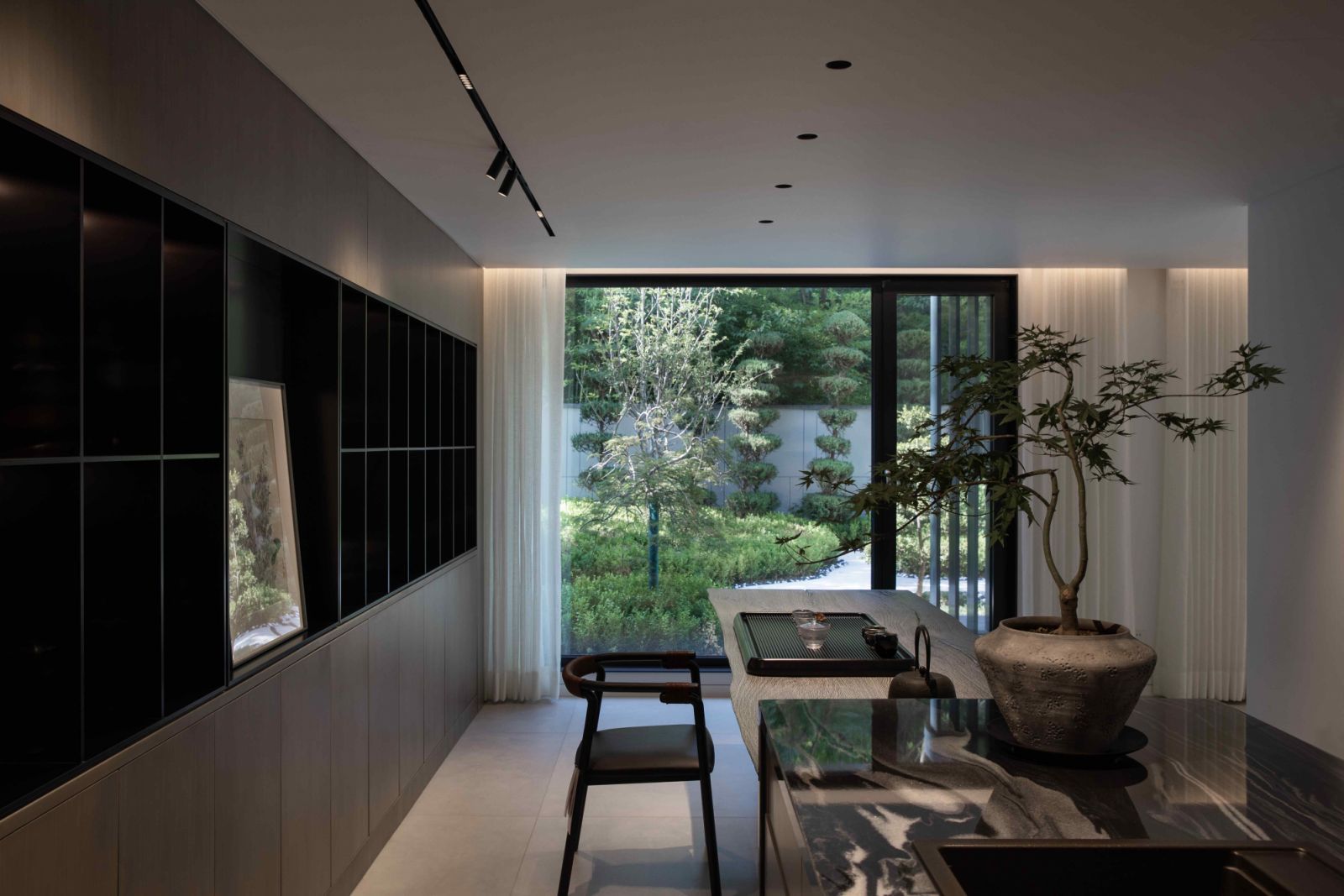 The serene tea room adjacent to the living room with comparable views of the garden