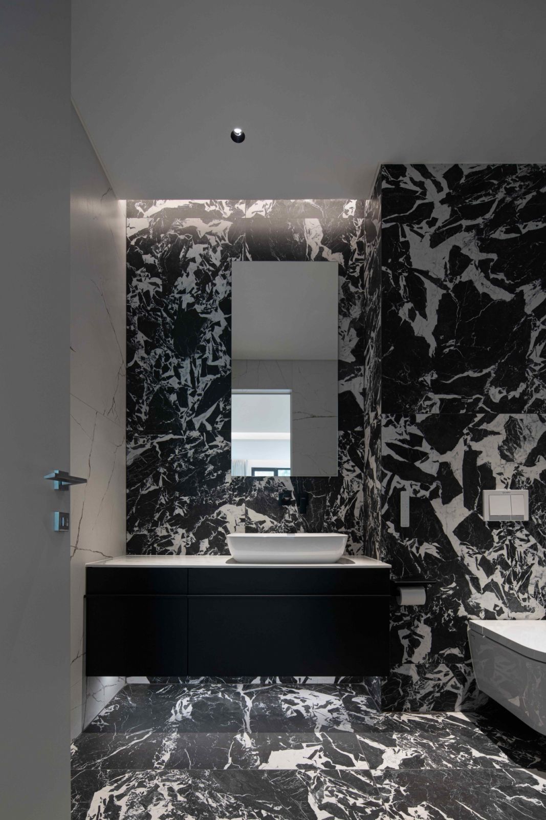 Luxurious black-and-white marble in one of the bathrooms